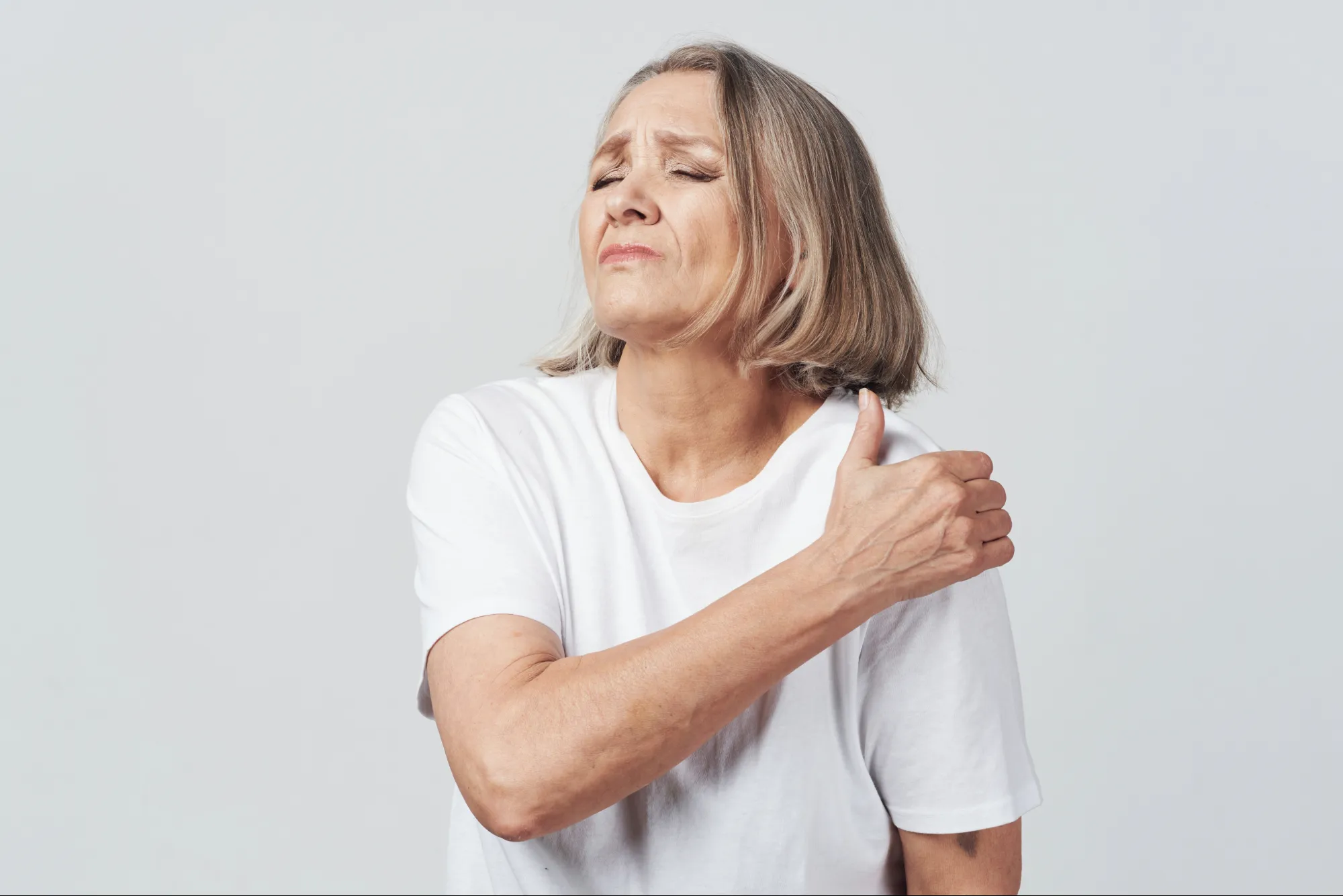 Someone in pain from a frozen shoulder.
